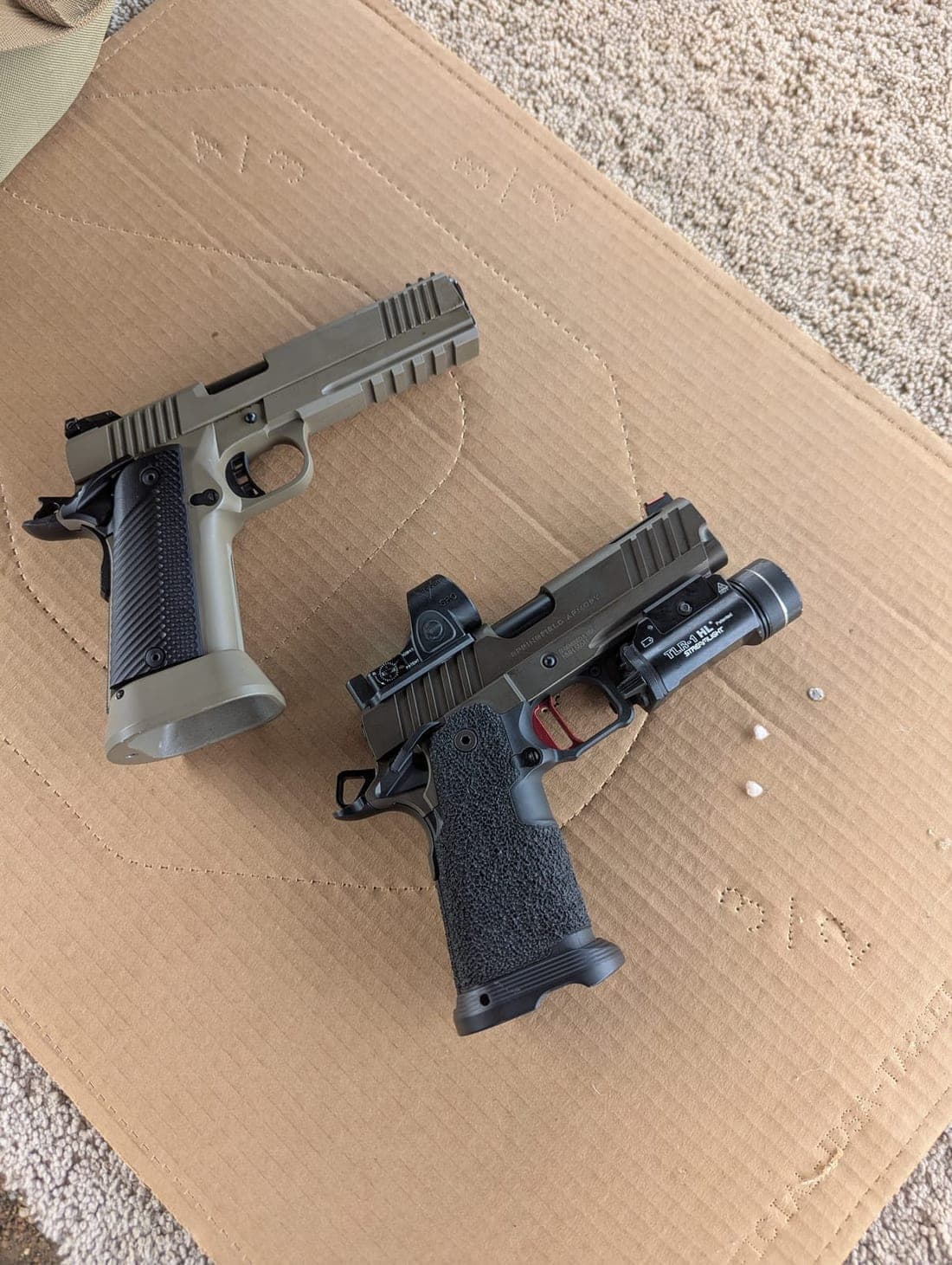 The finished tan pistol next to another double-stack pistol fitted with a red dot and weapon light